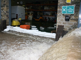 A small wall of FloodSax alternative sandbags prevented this torrent of floodwater from getting into a warehouse where it would have caused at least £360,000 damage