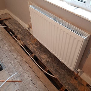 FloodSax preventing leaks beneath floorboards from radiator