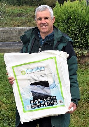 Forest of Dean District Council Cabinet member for the environment Clr Sid Phelps with a pack of 5 FloodSax alternative sandbags