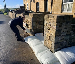 FloodSax being built into a sturdy protective wall against flooding