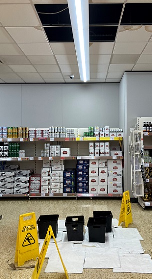 FloodSax preventing a slip hazard in a supermarket with water leaking through the ceiling