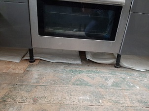 FloodSax beneath the kitchen units and oven in Christine Butler's flat