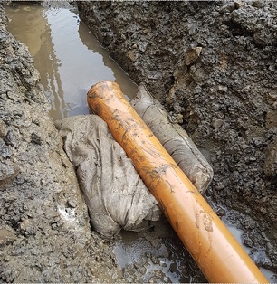 FloodSax alternative sandbag stopping water backing down a trench