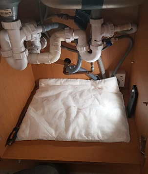 A FloodSax beneath this ‘spaghetti junction’ of plumbing underneath a sink meant plumber James Lucks could get his hands in to sort out a water problem