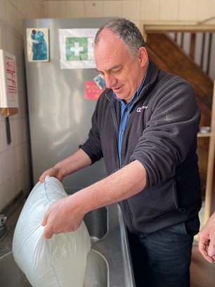 Prominent Green councillor Andrew Cooper testing out a FloodSax alternative sandbag to see for himself how well they work